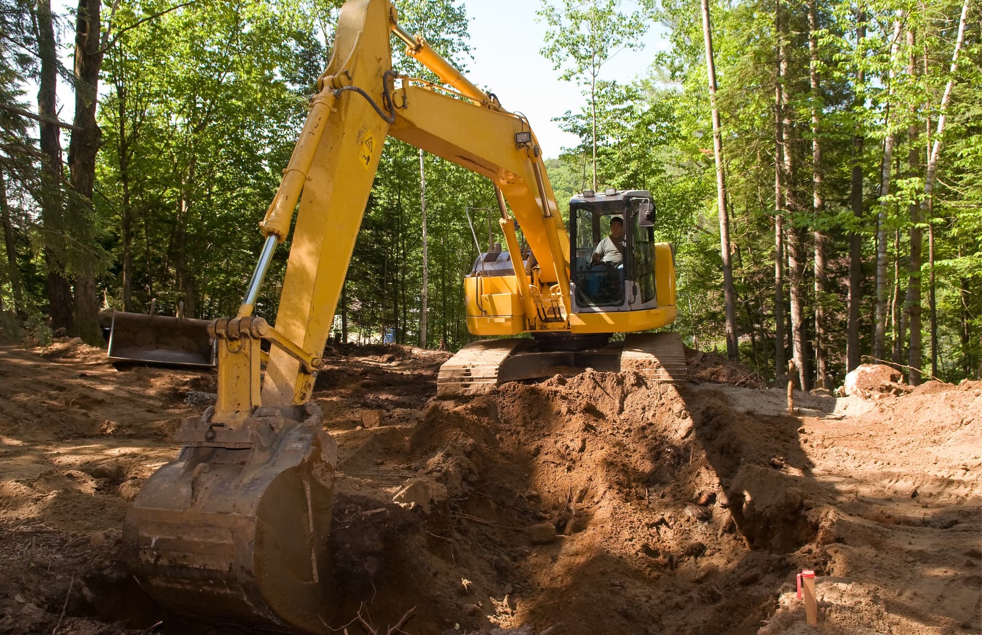 Excavator digging on a cleared building site near Duncan in the Cowichan Valley